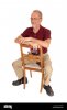 middle-age-man-sitting-backwards-on-chair-R3XP4H.jpg