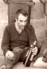7617185-drunk-man-siitng-on-sidewalk-near-trashcan-in-city-street.jpg