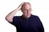 3642322-an-older-man-in-blue-shirt-and-glasses-rubbing-his-bald-head.jpg